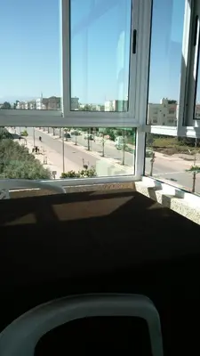 a window in a building with a view of a street at LOGEMENT HOTEL et NAVETTE GRATUITE in Fès