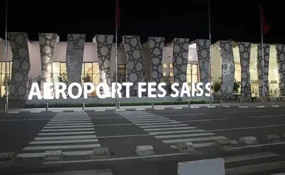 a large sign in front of a building at LOGEMENT HOTEL et NAVETTE GRATUITE in Fès