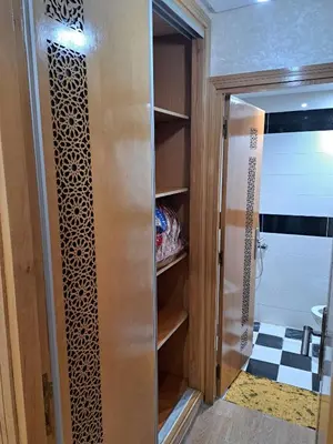 a walk in closet with a glass door in a bathroom at Appartement Au Centre Ville Prés de la Medina in Fès