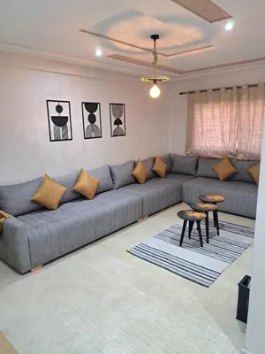 a living room with a couch and two tables at Appartement Au Centre Ville Prés de la Medina in Fès