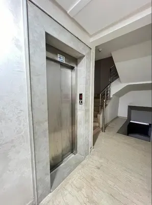 a hallway with a metal door in a building at Appartement Au Centre Ville Prés de la Medina in Fès