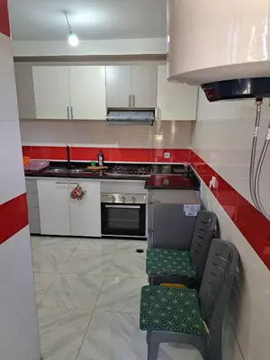 a kitchen with a stove and a chair in it at Appartement Au Centre Ville Prés de la Medina in Fès