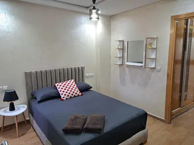a bedroom with a bed with two towels on it at Appartement Au Centre Ville Prés de la Medina in Fès
