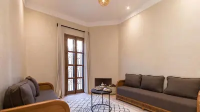 a living room with a couch and a table at Chez Ichou in Aït Idaïr