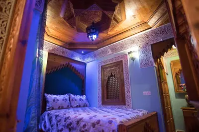 a bedroom with a bed with a blue ceiling at Riad Mehdi Meknès in Meknès