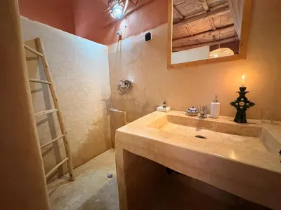 a bathroom with a sink and a mirror at Tigmi Hamid Découverte des traditions et de la culture berbère in Aït Ben Haddou
