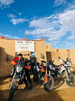 a group of motorcycles parked in front of a building at Riad Hotel Les Flamants in Merzouga