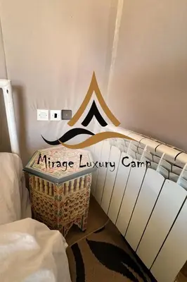 a bedroom with a bed with a nike luxury camp sign at Mirage Luxury Camp in Merzouga