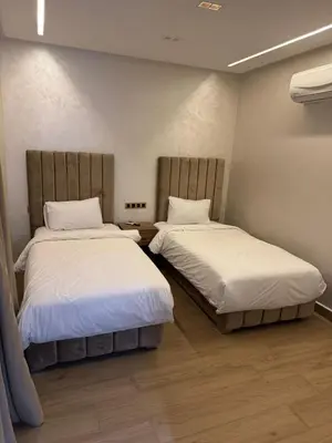 two beds in a room with two beds sidx sidx sidx sidx at HOTEL BORJ EL ARAB in Khouribga