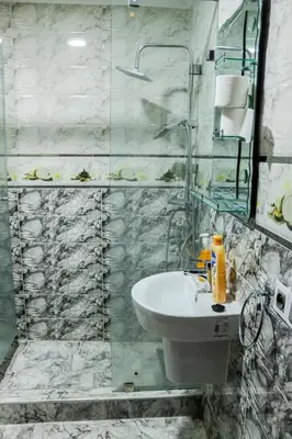 a bathroom with a sink and a glass shower at HOTEL BORJ EL ARAB in Khouribga