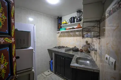 a small kitchen with a sink and a refrigerator at 105 Kasbah de Boujloud Fes Morocco. in Fès