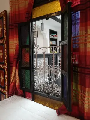 an open window with a view of a balcony at 105 Kasbah de Boujloud Fes Morocco. in Fès