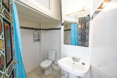 a bathroom with a toilet and a sink and a mirror at 105 Kasbah de Boujloud Fes Morocco. in Fès
