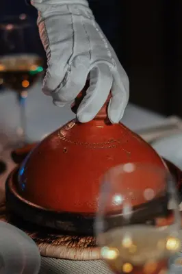 a hand with a glove on top of a fire hydrant at Riad Chebbi in Merzouga