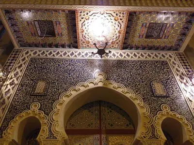 an ornate ceiling in a building with a chandelier at PALAIS LARAICHI Riad la porte bleue suites in Fès