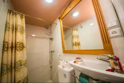 a bathroom with a sink and a shower and a mirror at PALAIS LARAICHI Riad la porte bleue suites in Fès