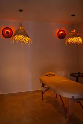 a room with a bench and lights on the wall at Le Rubis Oriental Marrakech in Azib Oulad Lâdem
