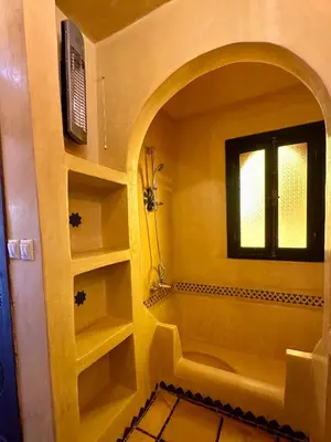 a bathroom with a window and shelves in a room at Le Rubis Oriental Marrakech in Azib Oulad Lâdem