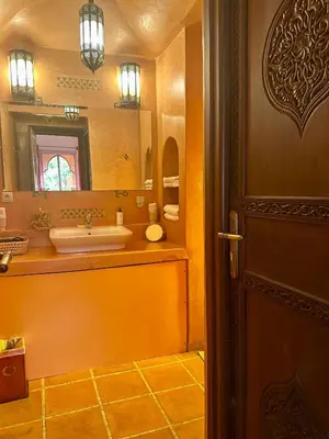 a bathroom with a sink and a mirror at Le Rubis Oriental Marrakech in Azib Oulad Lâdem