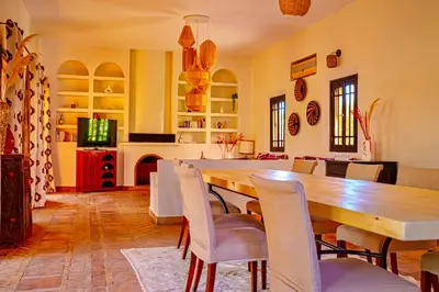 a dining room with a wooden table and chairs at Le Rubis Oriental Marrakech in Azib Oulad Lâdem