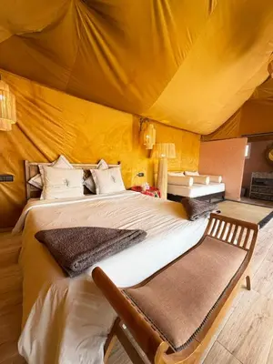 a bedroom with a large bed in a tent at Le Pacha Luxury Desert Camp - Mhamid Sahara Activities in Mhamid