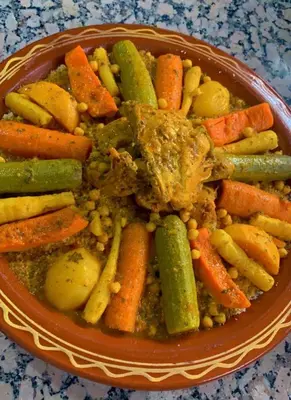 a bowl of food with vegetables on a table at Les Jardins Yasmina Bin el-Ouidane in Bine el Ouidane