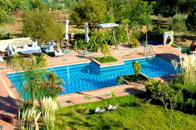 a swimming pool in the middle of a yard at Les Jardins Yasmina Bin el-Ouidane in Bine el Ouidane