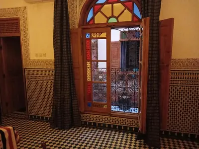 a door with a stained glass window in a room at Riad Dar Mystère in Fès