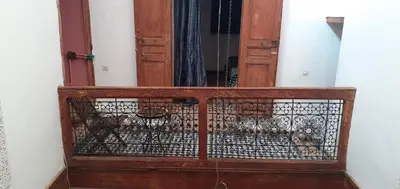 an old wooden door with a iron gate at Riad Dar Mystère in Fès