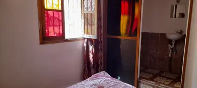a bathroom with a window and a sink and a shower at Riad Dar Mystère in Fès