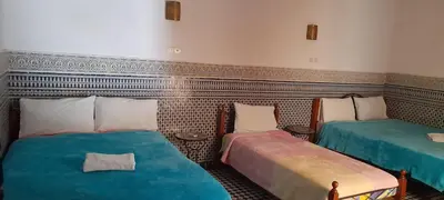 a room with two beds in a room at Riad Dar Mystère in Fès
