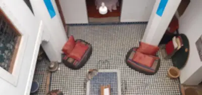 an overhead view of a living room with red pillows at Riad Dar Mystère in Fès