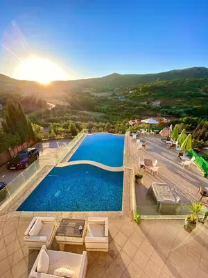an overhead view of a swimming pool with chairs and the sun at Dar Zayane in Khenifra