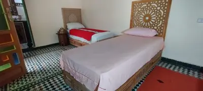 a bedroom with two beds in a room at Riad Ranya in Fès
