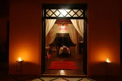 a hallway with a room with a table and two candles at Boutique Hôtel palais Masandoia in Erfoud