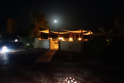 a night view of a house with a moon in the background at Boutique Hôtel palais Masandoia in Erfoud