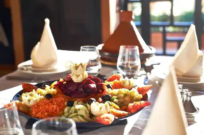 a plate of food on top of a table at Riad Bouchedor in Ouarzazate