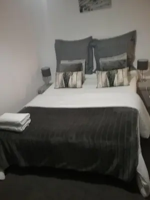 a bedroom with a large bed with two pillows at Appartement Moderne 3 Chambres in Fès