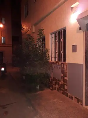 a building with a door and a plant on the side at Appartement Moderne 3 Chambres in Fès