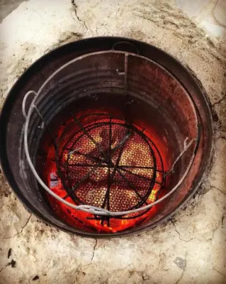 an overhead view of a fire pit with red liquid at Maison Boutchrafine in Erfoud