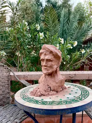 a stone statue sitting on top of a table at Hotel Carrefour des Nomades in Mhamid