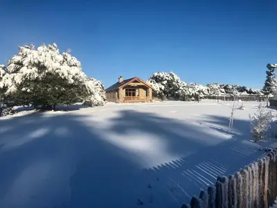 a snow covered yard with a house and a fence at Atlas Crown - Chalet de luxe in Ifrane