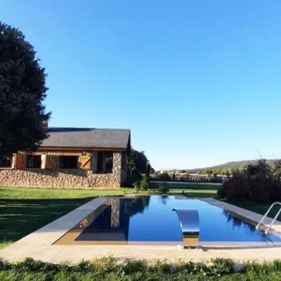 a pool with a chair in front of a house at Atlas Crown - Chalet de luxe in Ifrane