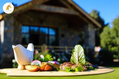 a plate of food on a table in front of a house at Atlas Crown - Chalet de luxe in Ifrane
