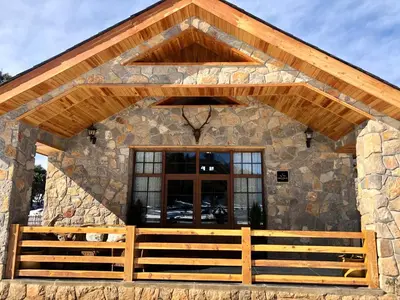 a stone building with a porch and a window at Atlas Crown - Chalet de luxe in Ifrane