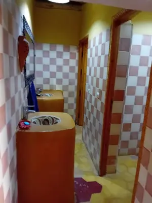 a bathroom with two toilets and two sinks at Maison d'Hôtes Agdal Telouet in Tiguidert