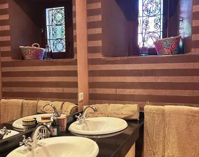 a bathroom with two sinks and stained glass windows at Villa Sophia in Azib Oulad Lâdem