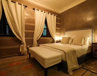 a bedroom with a large bed and a window at Villa Sophia in Azib Oulad Lâdem