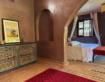 a bedroom with a bed and a dresser and a window at Villa Sophia in Azib Oulad Lâdem