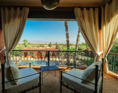 a room with a balcony with a view of the desert at Villa Sophia in Azib Oulad Lâdem